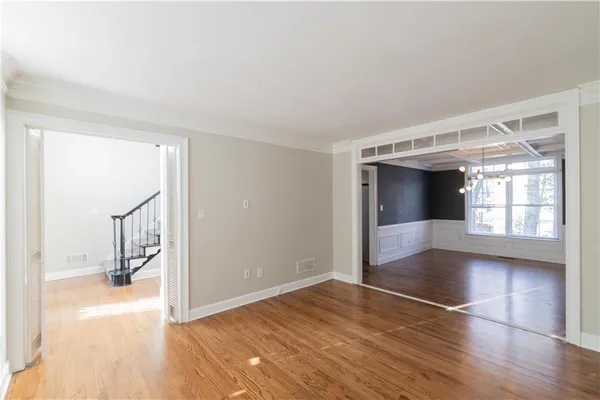 a view of entryway and hall with wooden floor