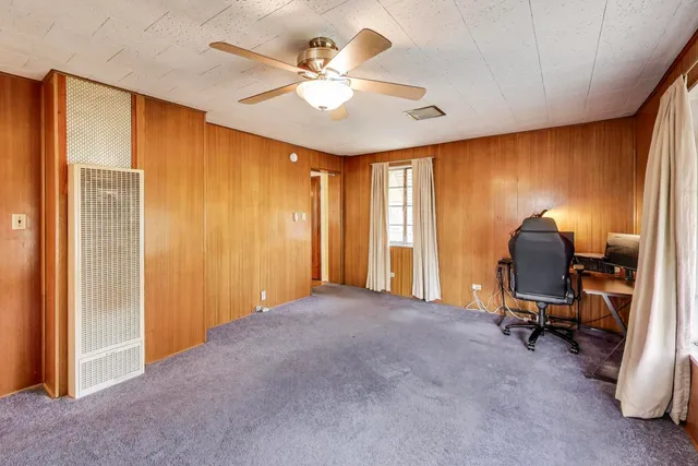 a view of a livingroom with workspace and a window