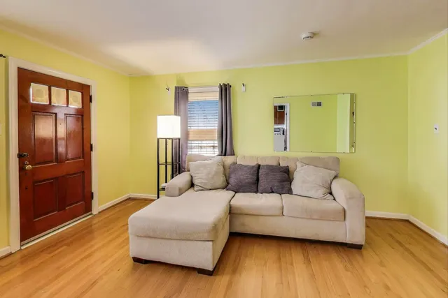a living room with a couch and dresser