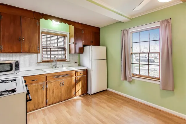 a kitchen with a refrigerator and window
