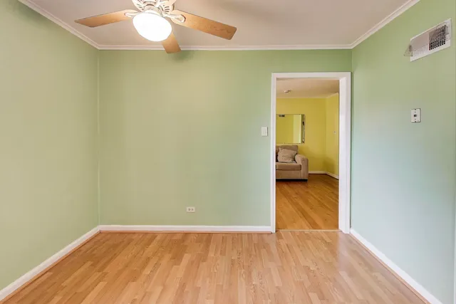 a view of a room with wooden floor a sink and a bathroom