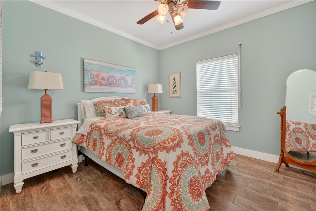 838 Rattlesnake Point Road Rockport, TX 78382 - Photo 19 of 40 a bedroom with a bed and wooden floor