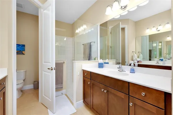 a spacious bathroom with a double vanity sink mirror and toilet