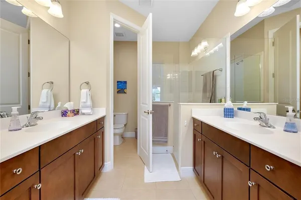 a bathroom with a double vanity sink mirror and double
