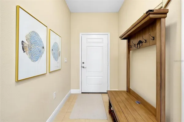 a view of a hallway with wooden floor and a bathroom