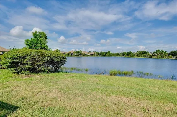 a view of a lake with houses in background