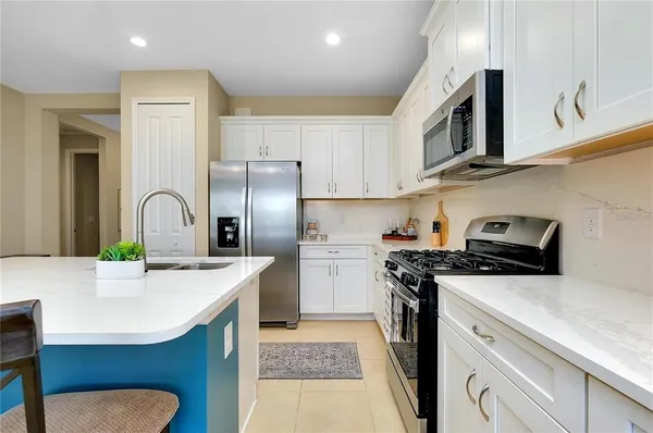 a kitchen with a sink a stove and refrigerator