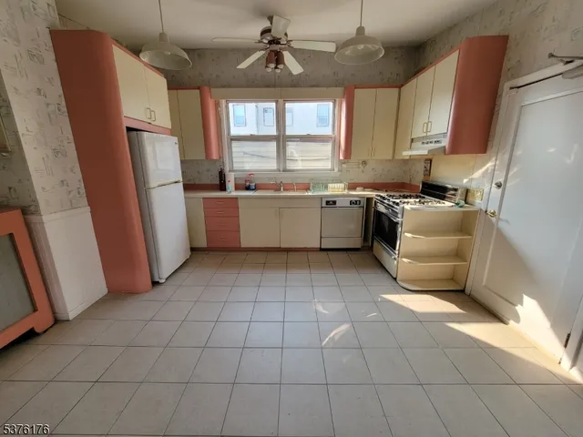 a kitchen with a refrigerator a stove a microwave and cabinets
