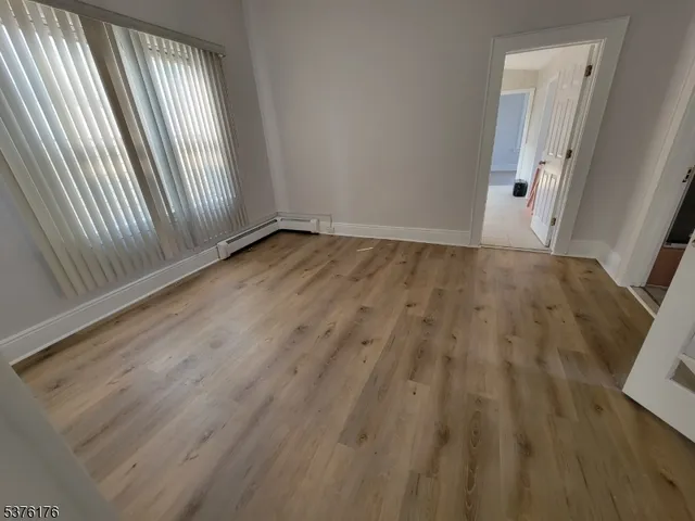 an empty room with wooden floor