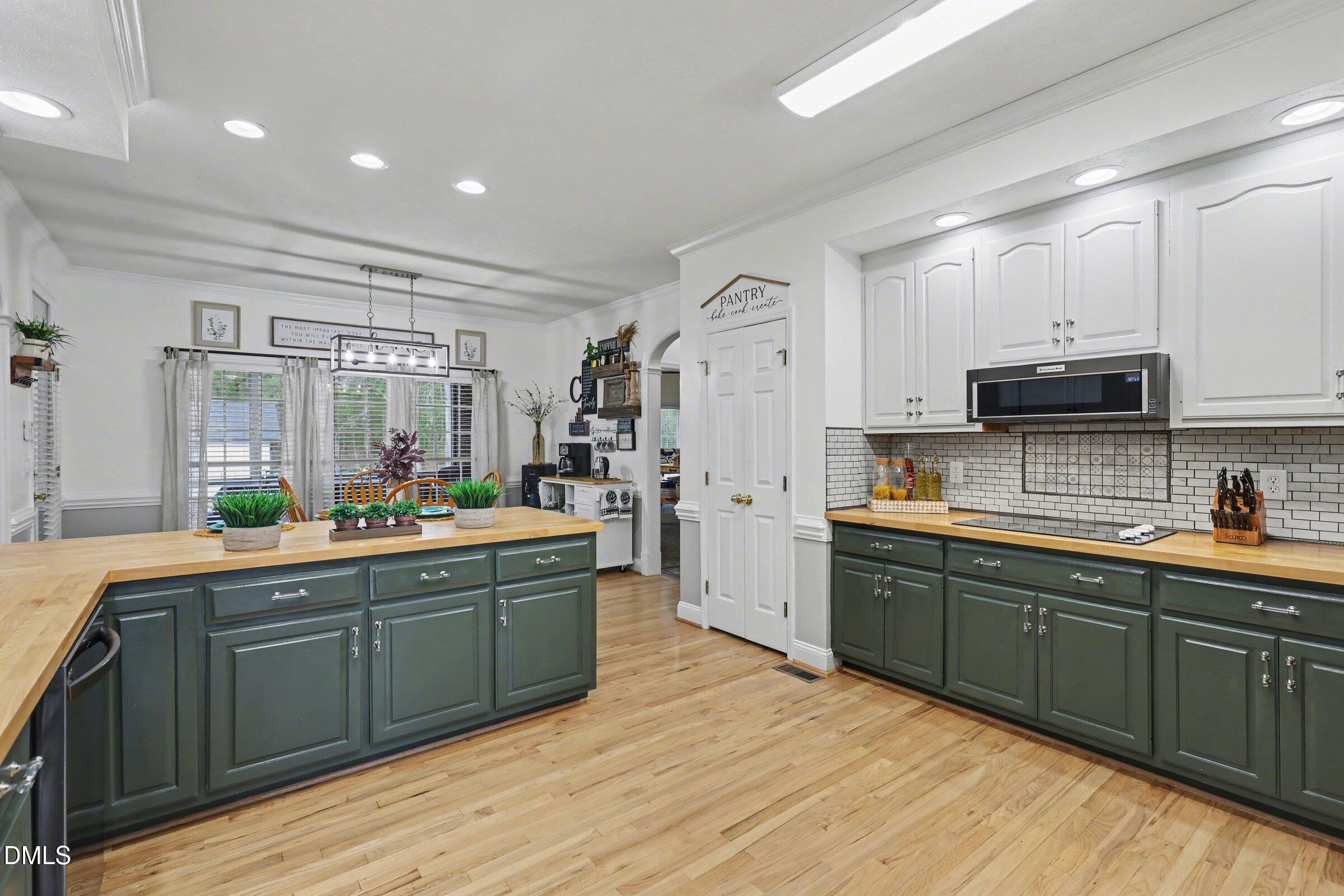 430 Fred Hall Road Stedman, NC 28391 - Photo 12 of 63 a large kitchen with stainless steel appliances kitchen island granite countertop a sink and cabinets