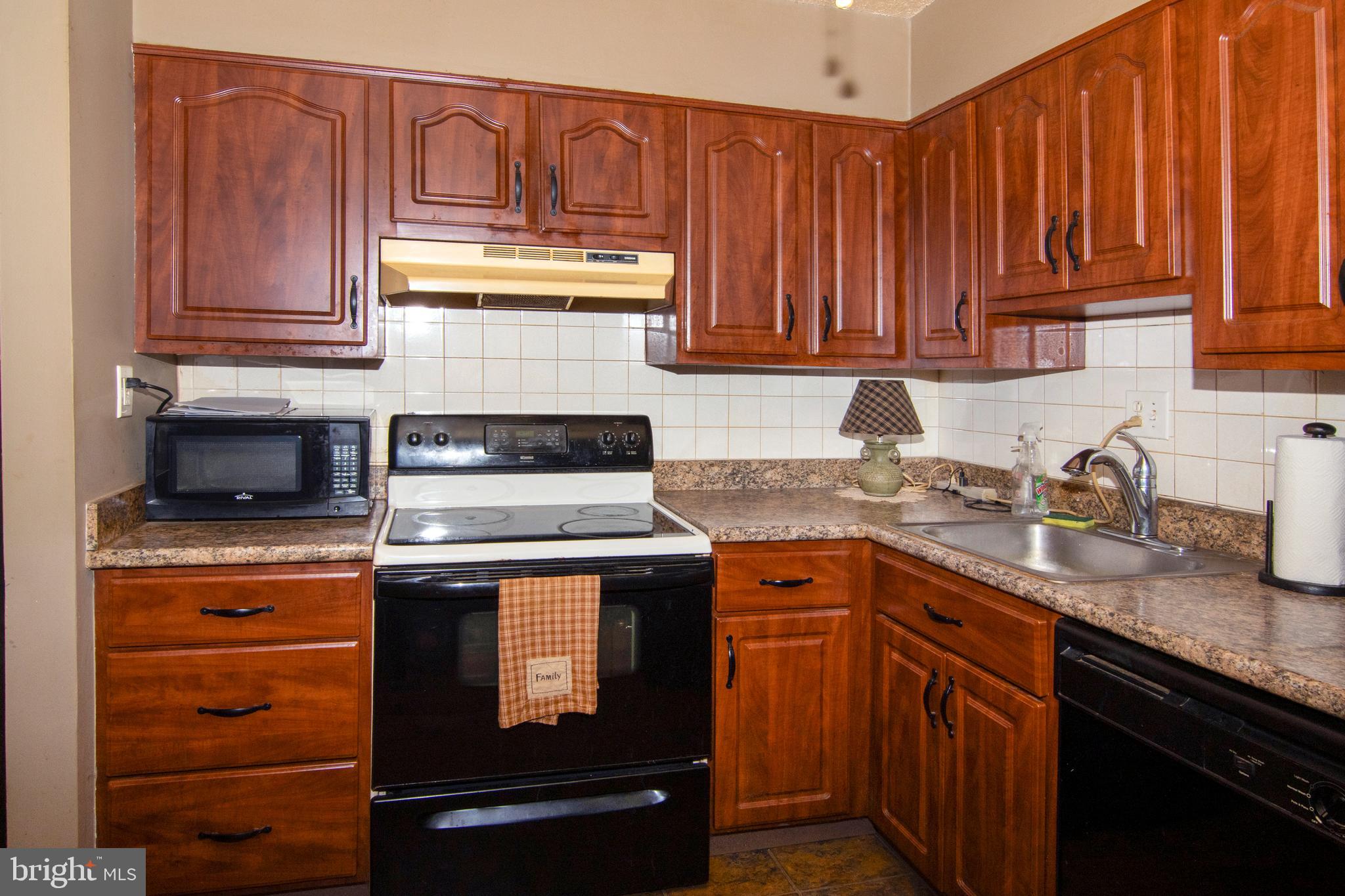 15 Dover Drive Lindenwold, NJ 08021 - Photo 11 of 24 a kitchen with granite countertop wood cabinets stainless steel appliances and a sink