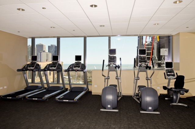 60 East Monroe Street, Unit 2205 Chicago, IL 60603 - Photo 11 of 22 a room with gym equipment and large mirror