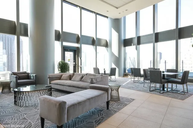 a living room with furniture and large windows