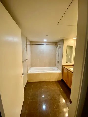 a bathroom with a tub and shower