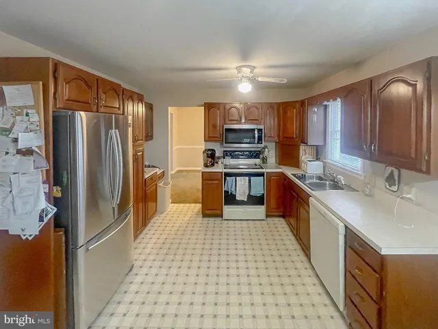 a kitchen with stainless steel appliances a refrigerator sink and microwave
