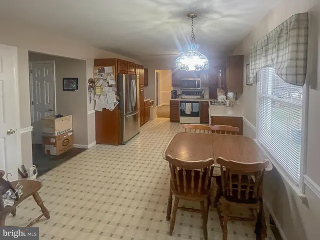 a dining room with furniture and window