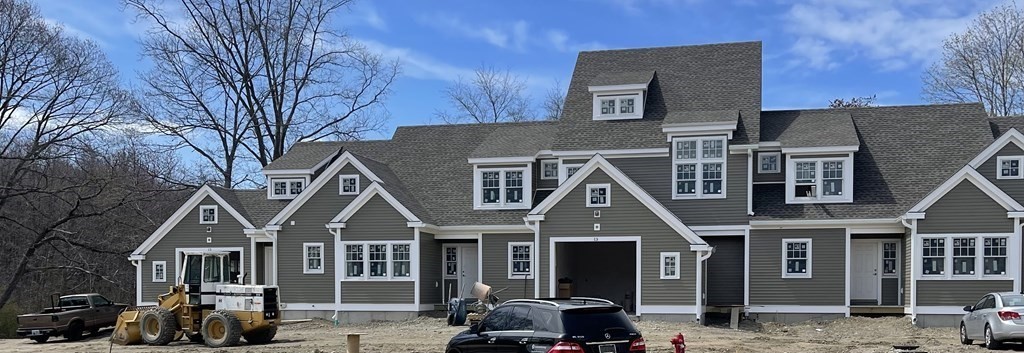 12 Main Street, Unit 13 Rowley, MA 01969 - Photo 1 of 9 a front view of a house with parking space