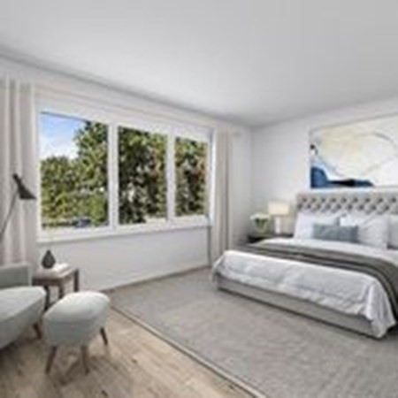 12 Main Street, Unit 13 Rowley, MA 01969 - Photo 8 of 9 a bedroom with a bed and a large window