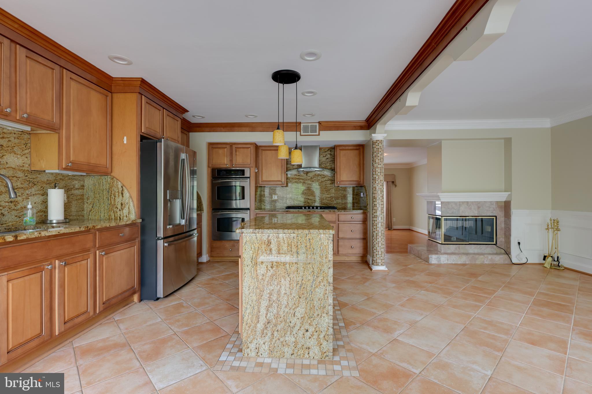 43440 Postrail Square Ashburn, VA 20147 - Photo 14 of 44 a kitchen with stainless steel appliances kitchen island granite countertop a refrigerator oven stove a sink and dishwasher