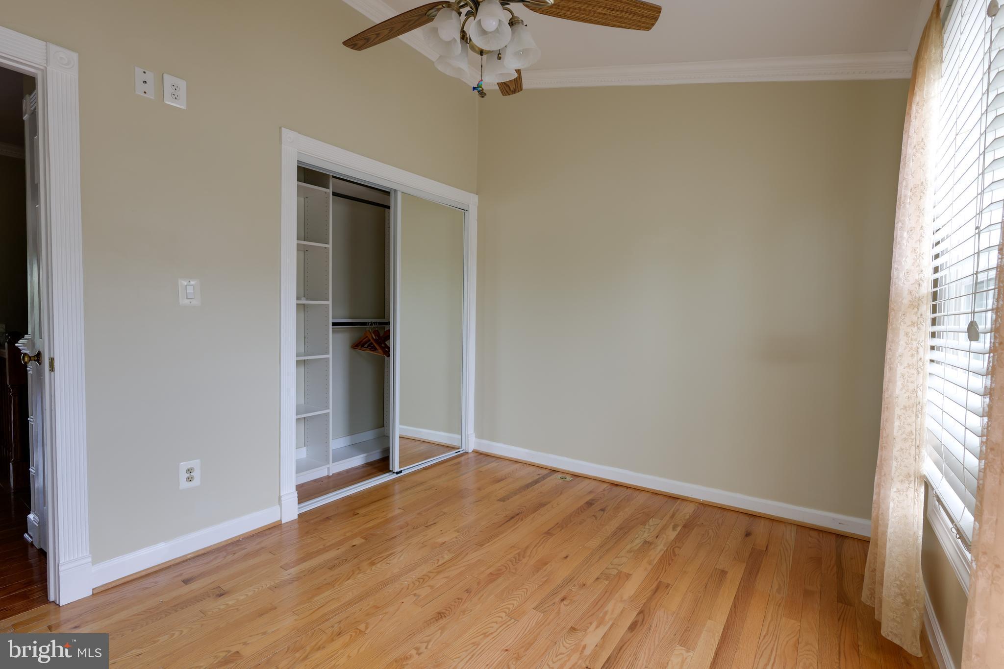 43440 Postrail Square Ashburn, VA 20147 - Photo 19 of 44 an empty room with wooden floor cabinet and windows