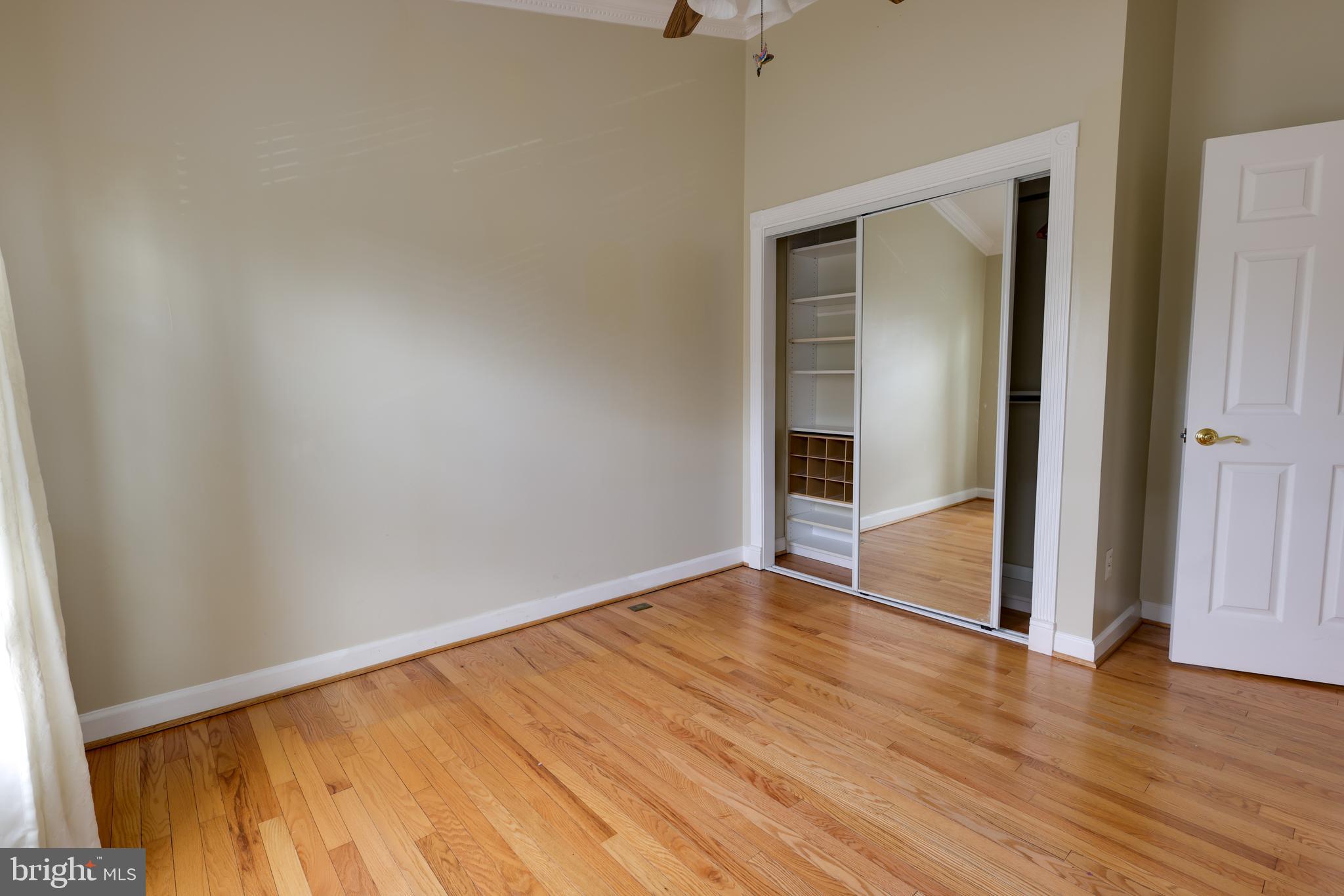 43440 Postrail Square Ashburn, VA 20147 - Photo 21 of 44 an empty room with wooden floor and entrance