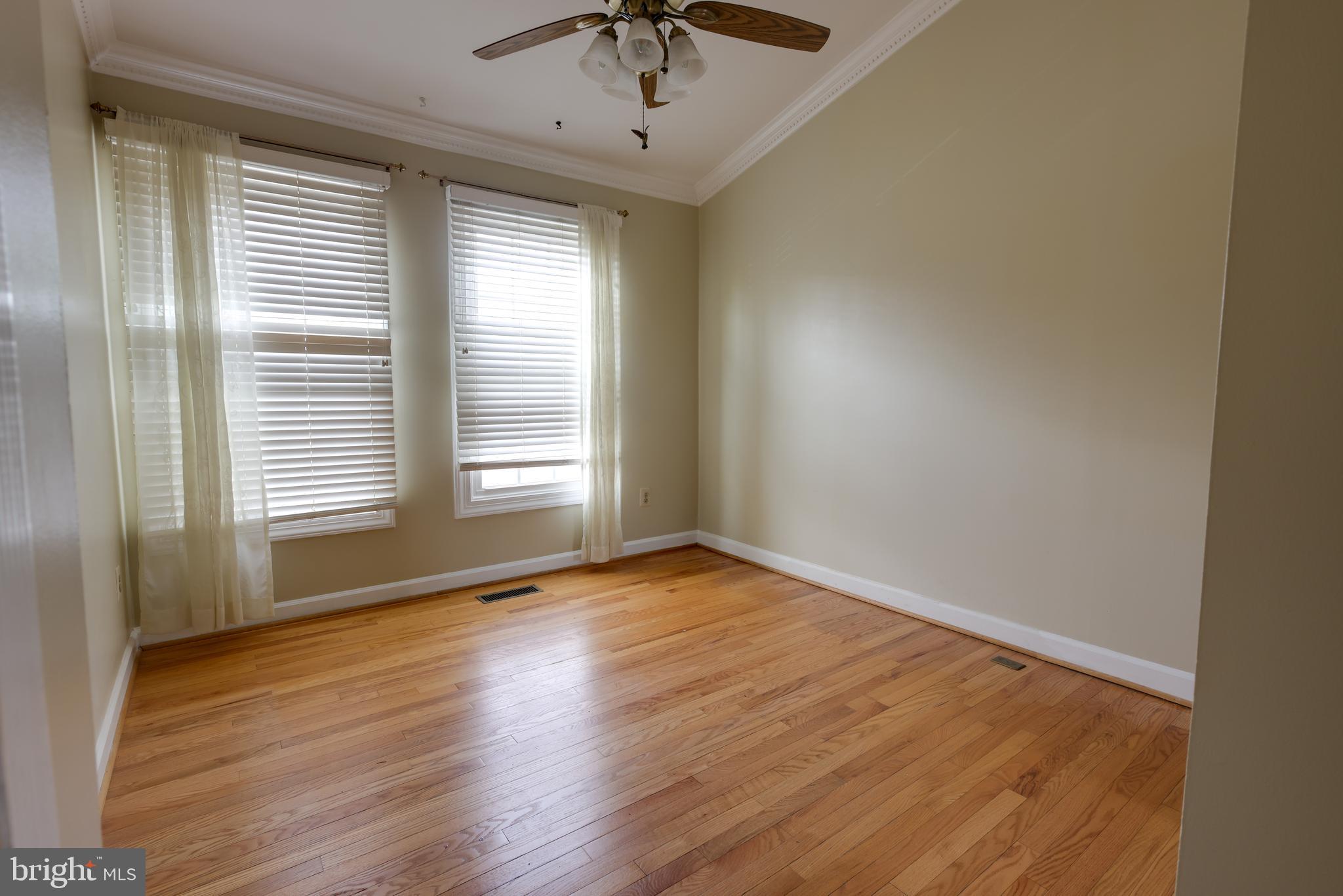 43440 Postrail Square Ashburn, VA 20147 - Photo 22 of 44 a view of an empty room with a window and wooden floor