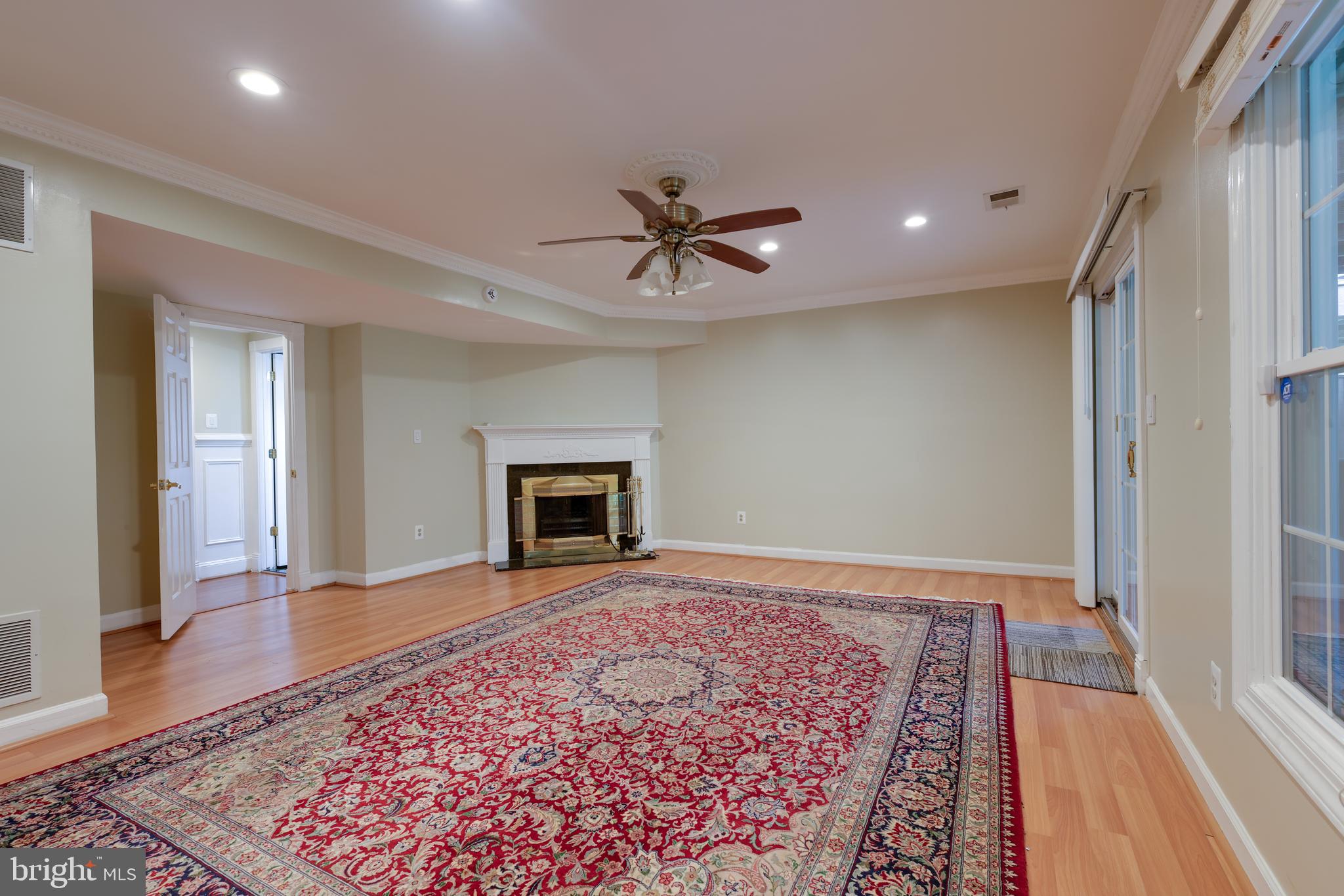 43440 Postrail Square Ashburn, VA 20147 - Photo 34 of 44 an empty room with chandelier fan and wooden floor