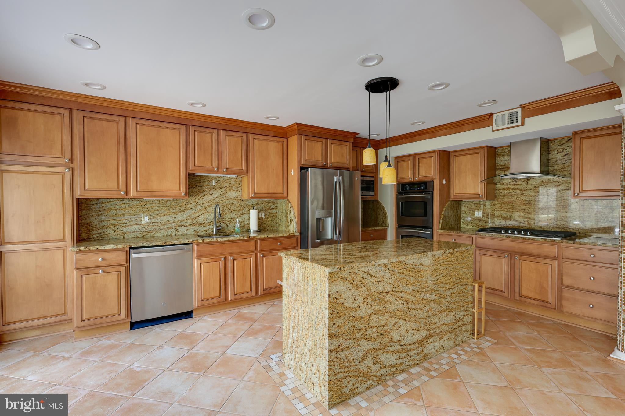 43440 Postrail Square Ashburn, VA 20147 - Photo 10 of 44 a kitchen with a refrigerator a stove top oven a sink and cabinets
