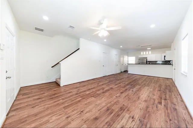 a view of an empty room and kitchen view