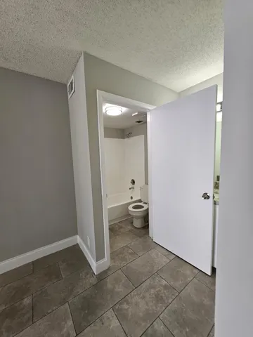 a view of a room with water heater and a cabinet