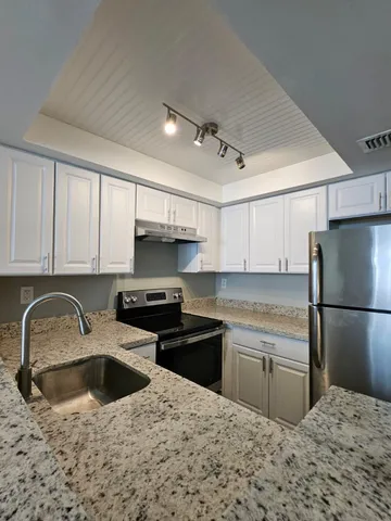 a kitchen with a sink stove and refrigerator