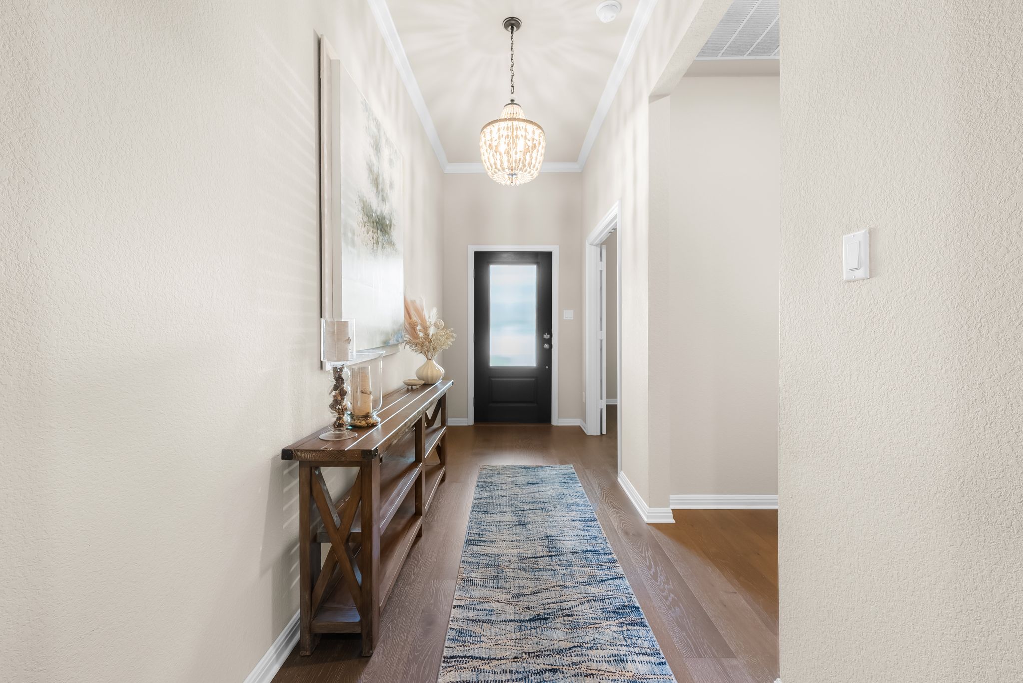 300 Prato Place Georgetown, TX 78628 - Photo 7 of 40 A graceful entry with warm wood flooring and elegant crown molding.
