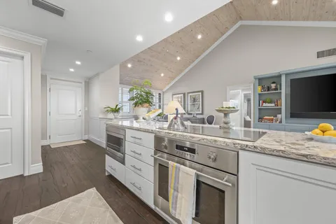 a kitchen with stainless steel appliances granite countertop a sink and a stove top oven
