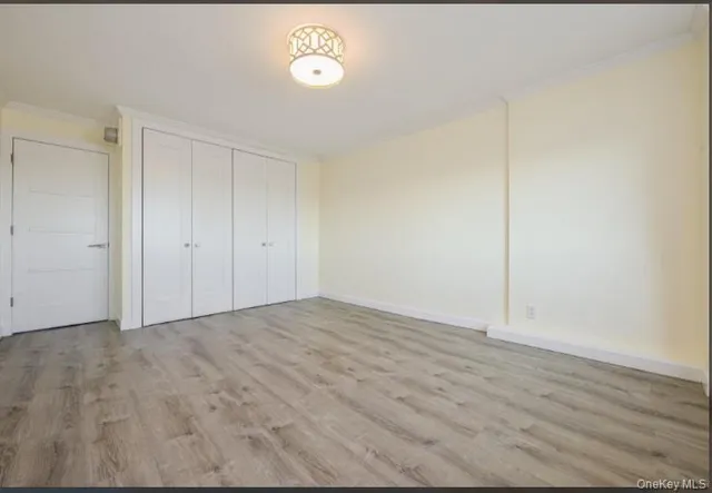 a view of an empty room and wooden floor