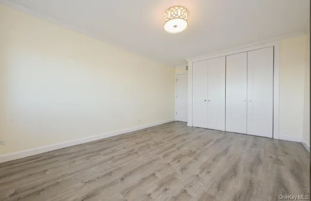 a view of an empty room and wooden floor