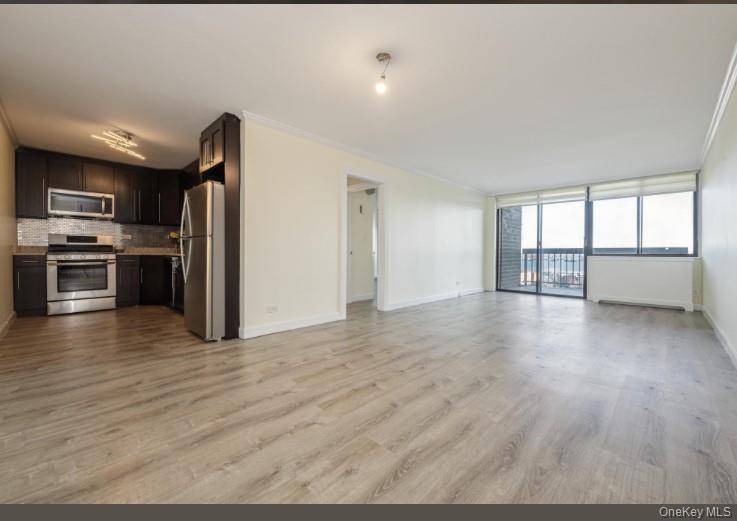 2 Bay Club Drive, Unit 17Z2 Queens, NY 11360 - Photo 6 of 17 a view of a kitchen with a sink stove refrigerator and cabinets