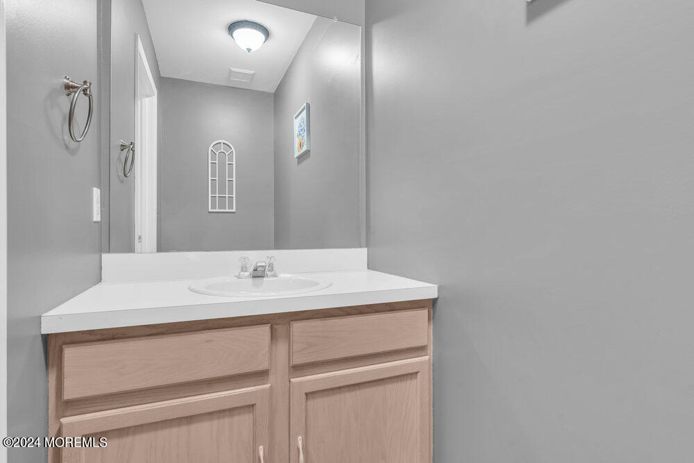 7 Andrew Street Howell, NJ 07731 - Photo 13 of 57 a bathroom with a sink vanity and a mirror
