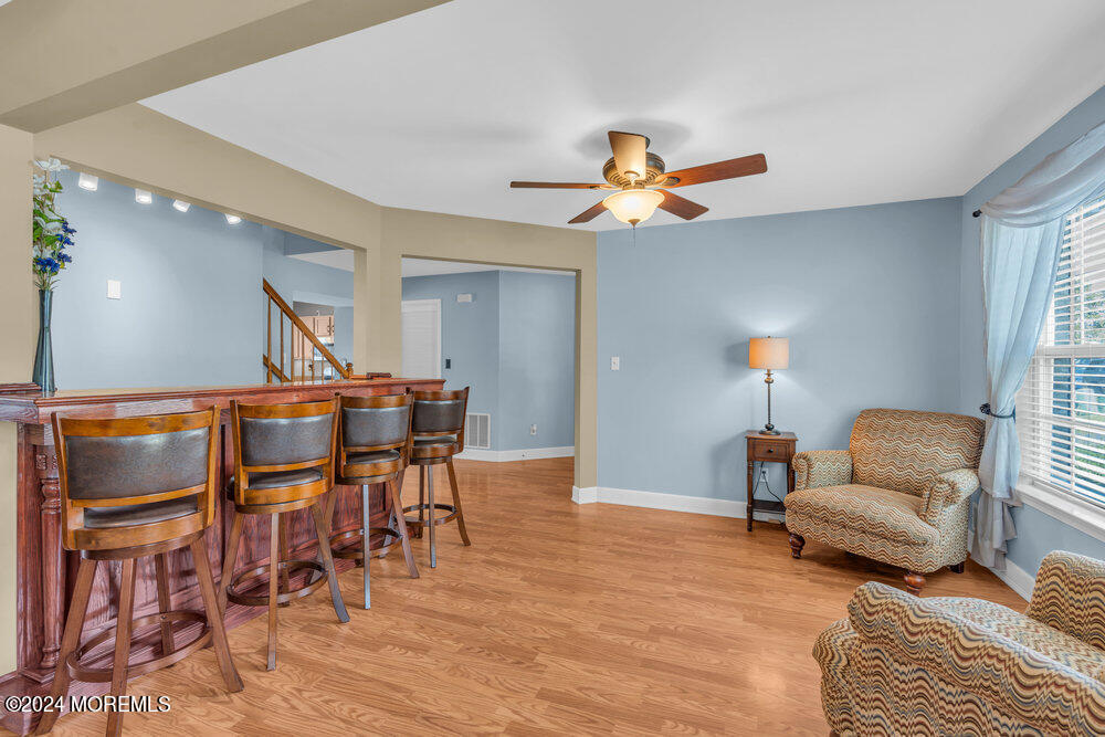 7 Andrew Street Howell, NJ 07731 - Photo 16 of 57 a living room with furniture and a wooden floor