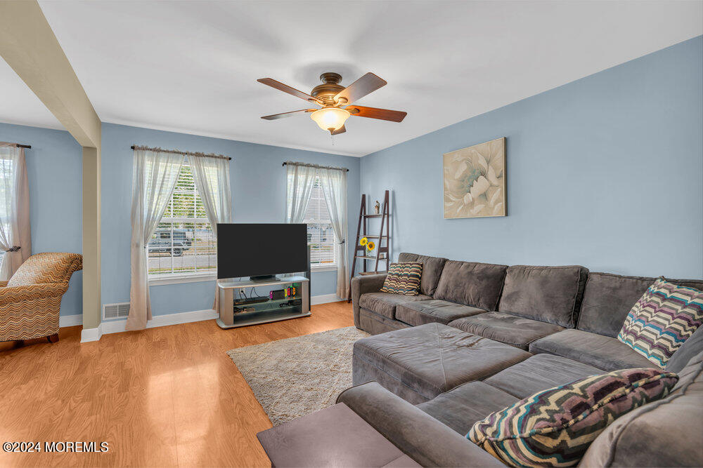 7 Andrew Street Howell, NJ 07731 - Photo 2 of 57 a living room with furniture and a flat screen tv with wooden floor