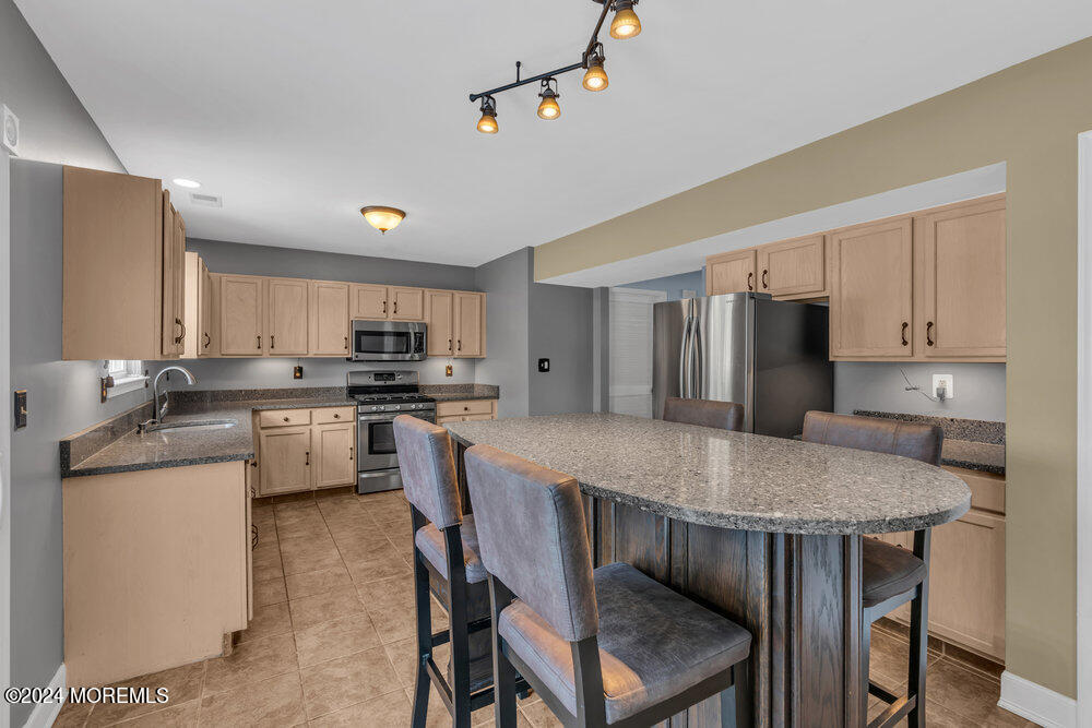 7 Andrew Street Howell, NJ 07731 - Photo 23 of 57 a kitchen with kitchen island a dining table and chairs