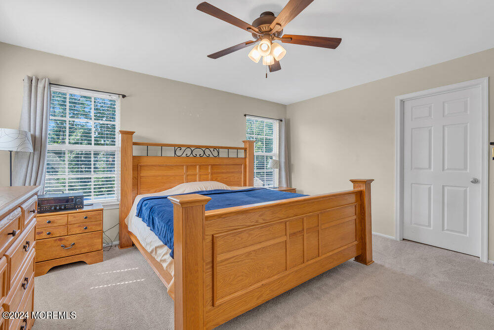 7 Andrew Street Howell, NJ 07731 - Photo 31 of 57 a bedroom with a bed and a chandelier