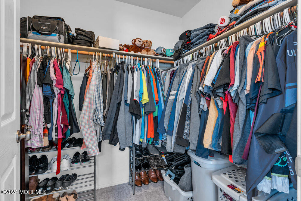 7 Andrew Street Howell, NJ 07731 - Photo 32 of 57 a view of walk in closet with clothes and shoes