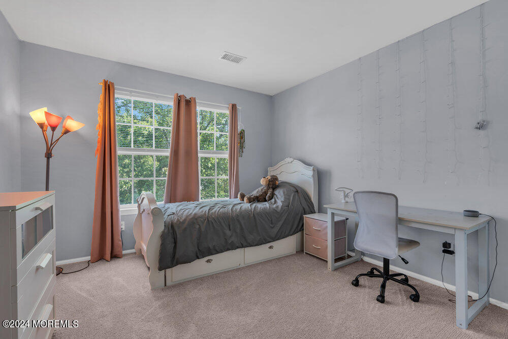 7 Andrew Street Howell, NJ 07731 - Photo 35 of 57 a bed room with a bed and a chair