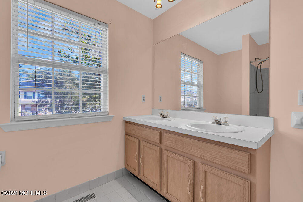 7 Andrew Street Howell, NJ 07731 - Photo 40 of 57 a bathroom with a sink a vanity a window and a mirror