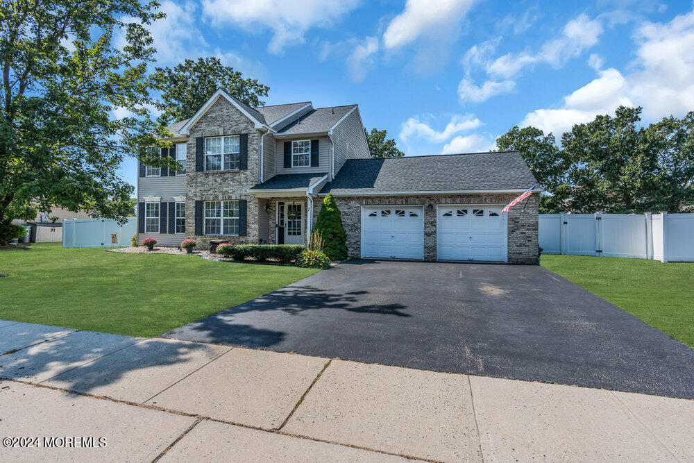 7 Andrew Street Howell, NJ 07731 - Photo 8 of 57 a front view of a house with a yard and garage