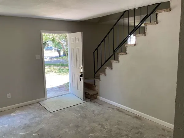 a view of an empty room with stairs