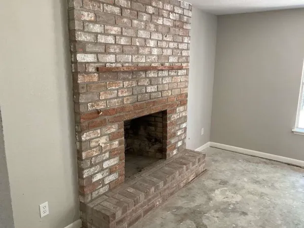 a view of empty room with a fireplace