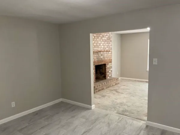 a view of empty room with a fireplace