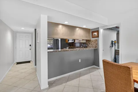 a view of kitchen with furniture and refrigerator