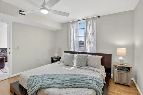 a bedroom with a bed and a chandelier
